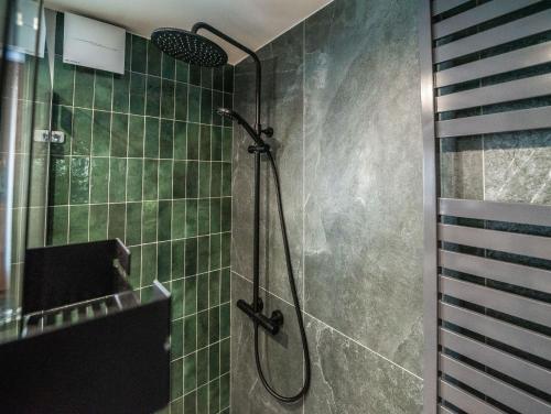 a bathroom with a shower with green tiles at Kościerzynkowo in Kościerzyna