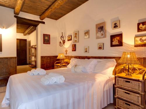 a bedroom with a large bed with towels on it at Riserva Privata San Settimio in Arcevia