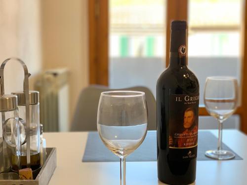 a bottle of wine and a glass on a table at SMartspot Rosia in Rosia