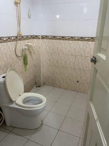 a bathroom with a toilet with the lid up at REYALI GUEST HOUSE in Male City