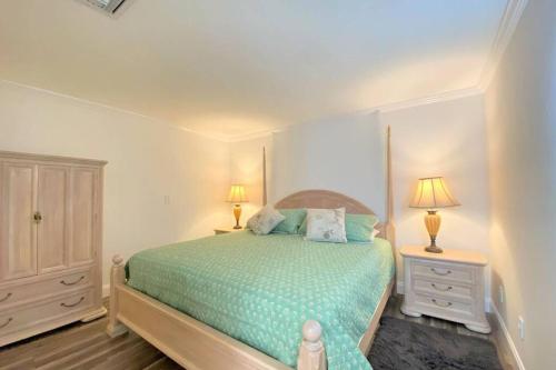 a bedroom with a bed with two night stands and two lamps at Cheerfull 4/bed/ 3 Bath / pool / best Location in Naples