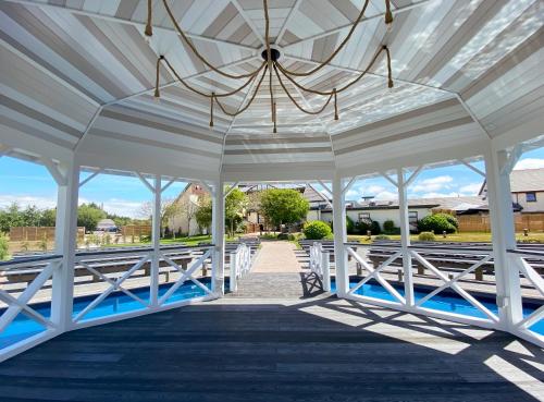 a white pavilion with a chandelier on it at The Gailes Hotel & Spa in Irvine