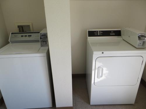 a white washer and dryer in a room at AmericInn by Wyndham Menomonie in Menomonie