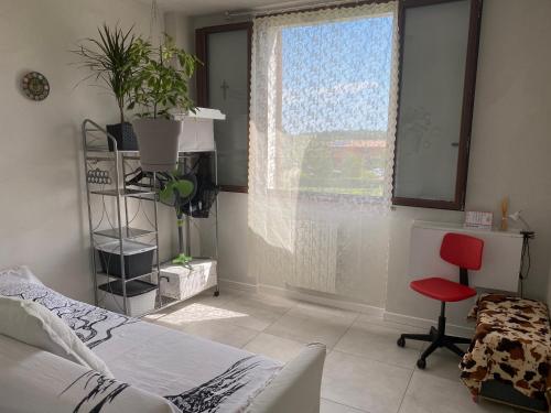 a bedroom with a bed and a window and a chair at Camera Monica in Peschiera del Garda
