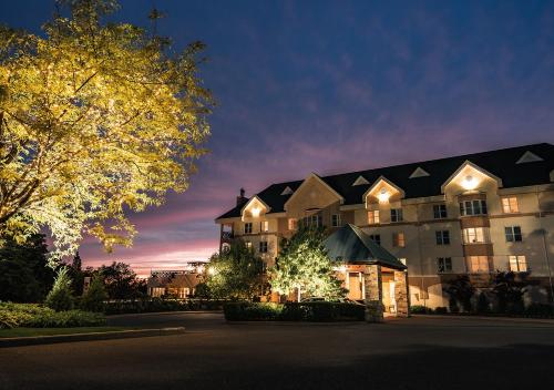 a large building is lit up at night at Hotel Chateau Bromont in Bromont