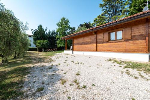a large yard in front of a wooden building at Villa degli Ulivi in Lempa