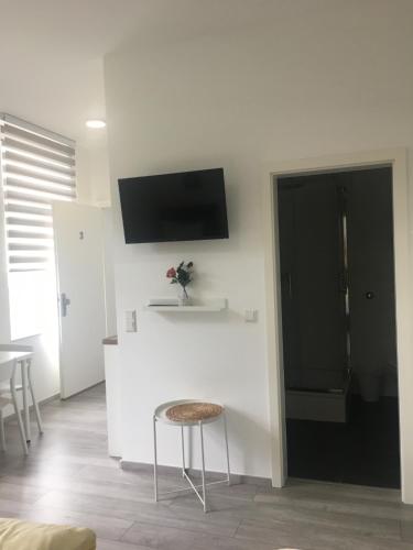 a kitchen with a counter and a tv on the wall at Apartment Dusseldorf-City in Düsseldorf