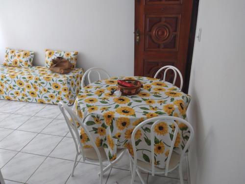 a table and chairs with a tablecloth with flowers on it at Nosso Canto in Recife