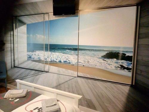 a room with a picture of the ocean on the wall at A l'Escale in Gauriac