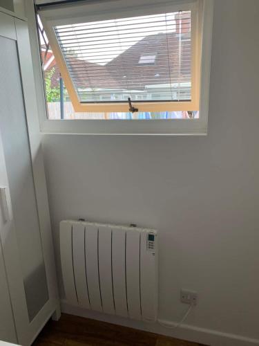 a window in a room with a radiator in front of it at Lindas LODGE Free PARKING air con plus provisions included in Hove