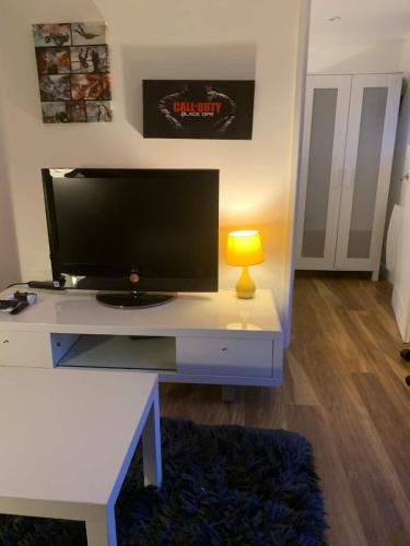 a living room with a tv on a white desk at Lindas LODGE Free PARKING air con plus provisions included in Hove