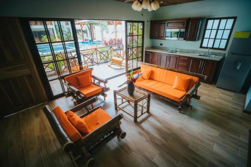an overhead view of a living room with orange furniture at Bungalows Punta Uva in Punta Uva