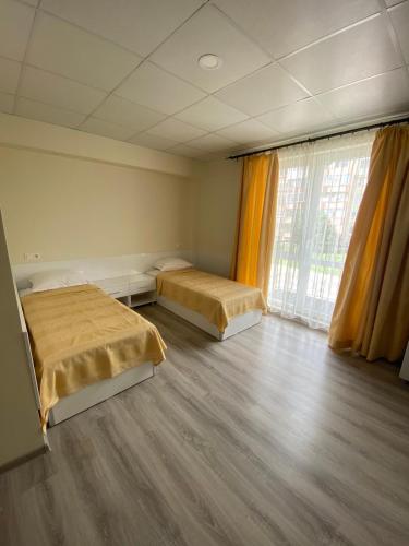 a room with two beds and a large window at КОМПЛЕКС ОКЕЙ in Shumen