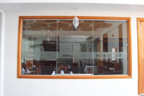 a reflection of a dining room in a window at Flower's House MachuPicchu in Machu Picchu