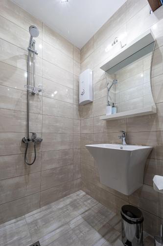 a bathroom with a sink and a shower at Villa EUPHORIA in Ridovo