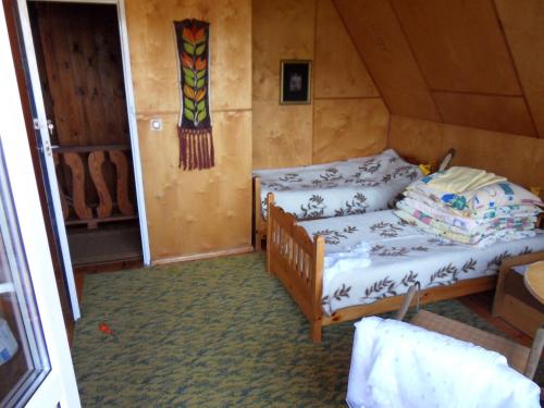 a bedroom with a bed in a room at Blizniak nad Morzem in Rowy