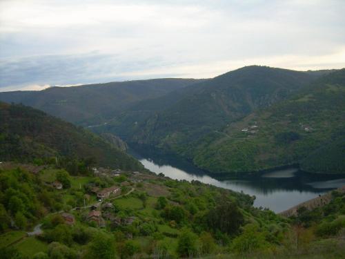a view of a river in a valley with mountains at Rectoral de Castillon in Pantón