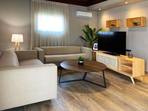 a living room with a couch and a flat screen tv at La Marina Resort in La Marina