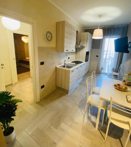 a kitchen and dining room with a table and chairs at Home Sweet Home in Campobasso