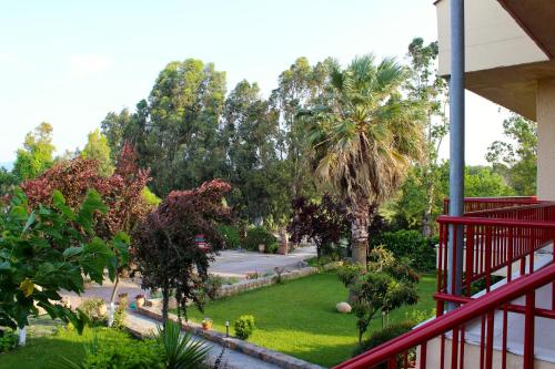 a view of a garden from the balcony of a house at Aenaon Studios in Oreoí