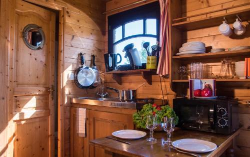 a kitchen with a sink and a window in a cabin at Le Village de la Champagne - Slowmoov in Bar-sur-Aube