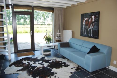 a living room with a couch and a rug at Bed & Breakfast Langlaar in Nuenen