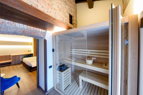 a room with a walk in shower and a bedroom at Relais & Spa Castello di Casiglio in Erba