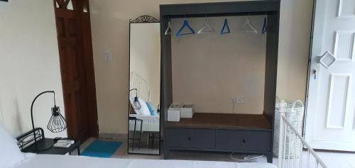 a mirror in a room with a bed and a bedroom at Black Fig in Pollonia
