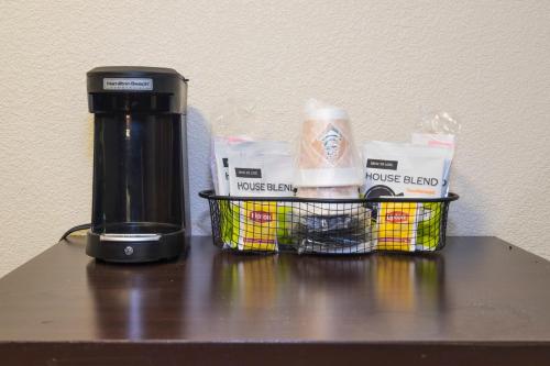 a coffee maker and a basket on a table at Red Roof Inn PLUS+ Columbus Downtown - Convention Center in Columbus