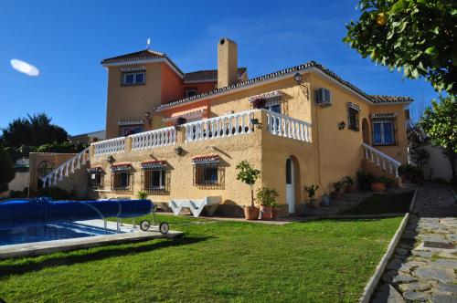 a large house with a swimming pool in front of it at Casa de los Limones by Michael FAMILY VILLA NEAR PUERTO MARINA in Benalmádena