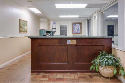 a reception desk in a waiting room with a plant at Days Inn by Wyndham Asheville West in Candler