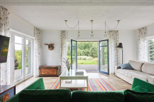 a living room with a couch and a table at Siedlisko Wnukowo in Szczechy Małe