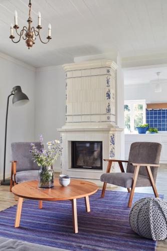 a living room with a table and a fireplace at Siedlisko Wnukowo in Szczechy Małe