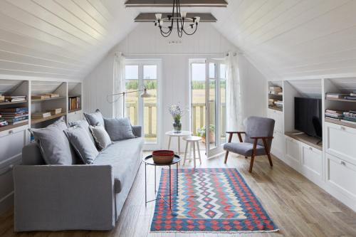 a living room with a couch and a chair at Siedlisko Wnukowo in Szczechy Małe
