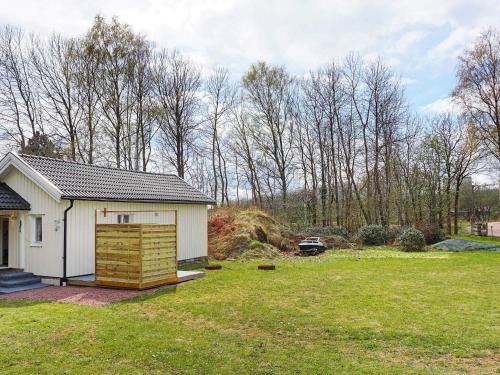 a small white house in a grassy yard at 4 person holiday home in LYSEKIL-By Traum in Lysekil