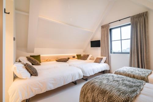 Cama o camas de una habitación en De Kaleihoeve