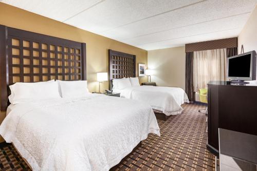 a hotel room with two beds and a flat screen tv at Comfort Inn Sherman in Sherman