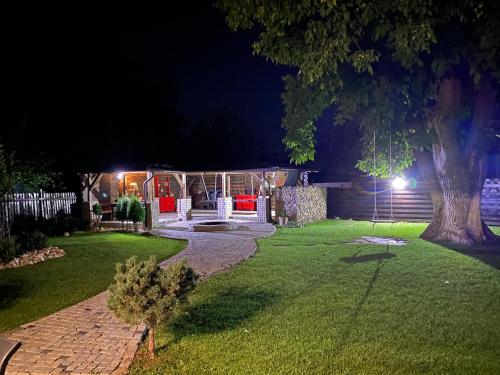 a backyard at night with a gazebo at Casa Pisica Noastra in Breaza