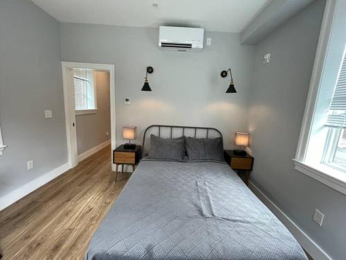 a bedroom with a large bed and two lamps at The King Suite at Prince Street Inn ADA Accessible in Alexandria