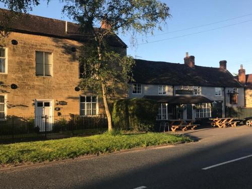 a large brick building on the side of a street at The Crown Inn, Kemerton in Tewkesbury