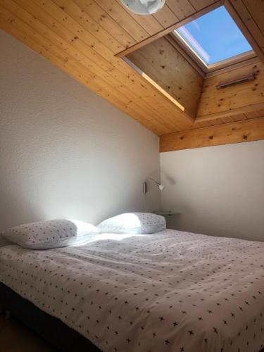 a bedroom with a bed with a wooden ceiling at appartement in de Haute Savoie (Saint Jean de Sixt) in Saint-Jean-de-Sixt