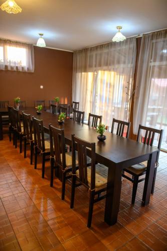 a dining room with a long table and chairs at Вилен комплекс Дарибел in Sapareva Banya