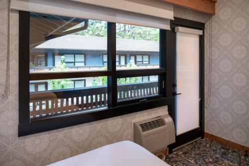 a window with a view of a balcony at The Dorothy Motel in Banff