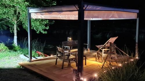 a wooden deck with a gazebo at night at Moonriver Apartment in Veljun