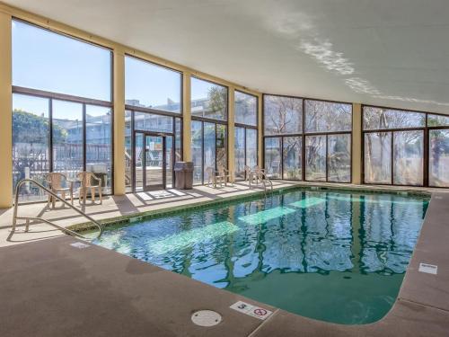 a swimming pool in a building with windows at Updated Condo. Great for families. Seaside Beach and Racquet Club 5717 in Orange Beach