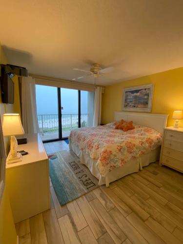 a bedroom with a bed and a view of the ocean at Updated Condo. Great for families. Seaside Beach and Racquet Club 5717 in Orange Beach