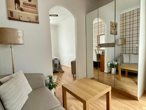 a living room with a couch and a table at Little Connaught 2 bed House pet friendly in Portsmouth