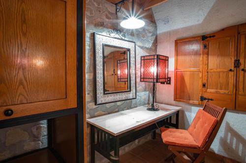 a room with a table and a mirror and a chair at Termas de San Joaquin in El Ranchito