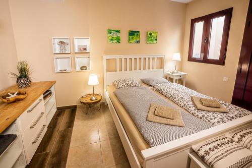a bedroom with a large bed with two pillows at casamarena in Costa Calma
