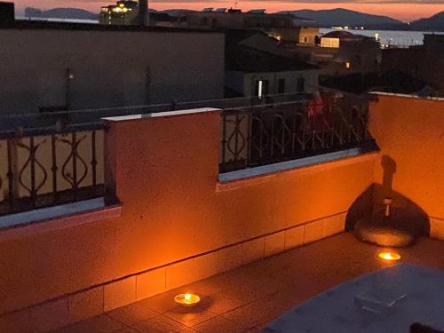 a balcony with lights on the side of a building at B&B Su Canistreddu in Alghero